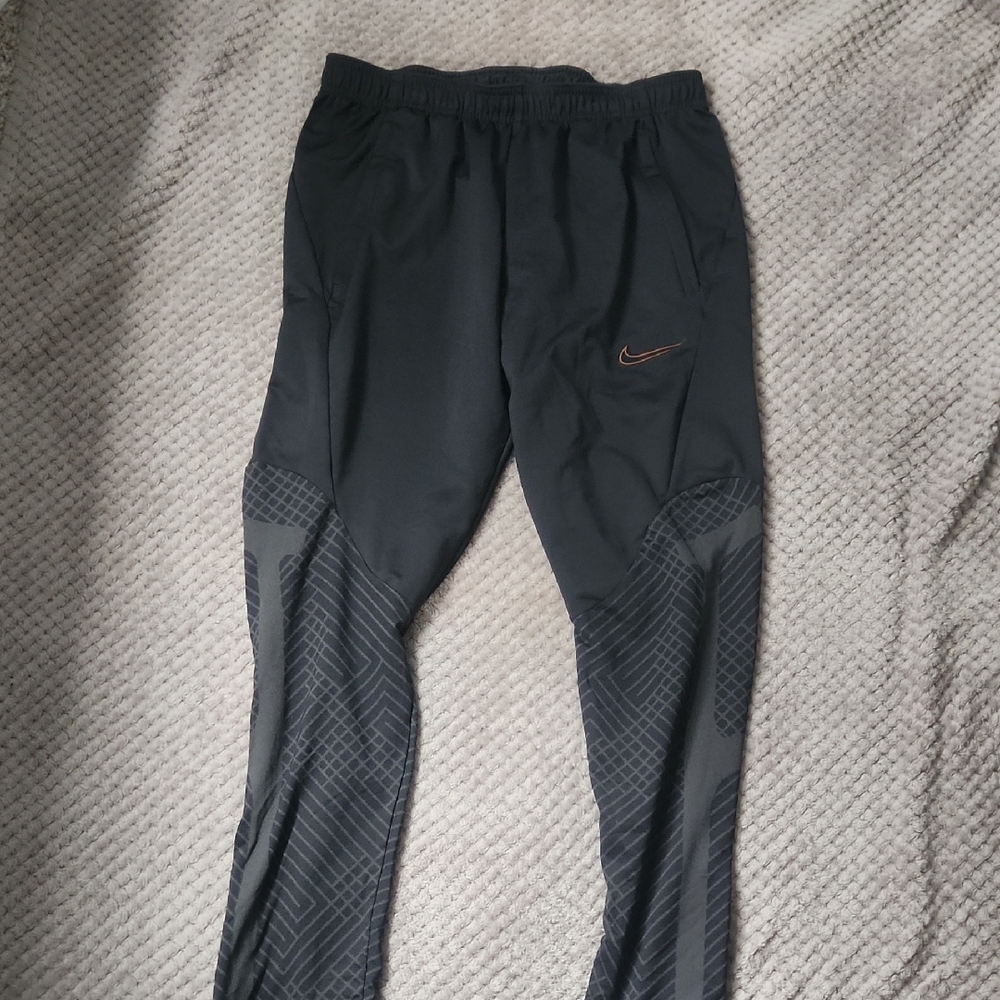 Black Nike Athletic Pants with Orange Swoosh